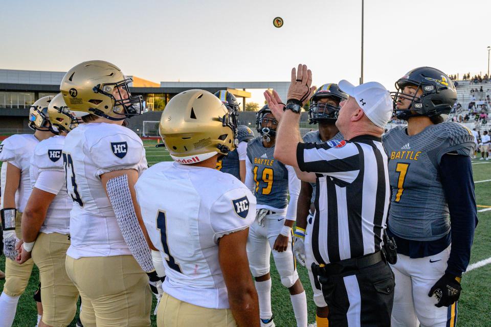 The Battle and Helias football captains await the result of the coin toss before a game against Helias at Battle High School on Sept. 8, 2023, in Columbia, Mo.