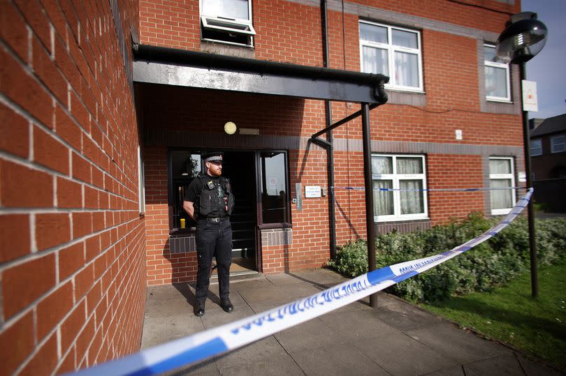 The scene at Bowling Green Court flats -Credit:Sean Hansford | Manchester Evening News