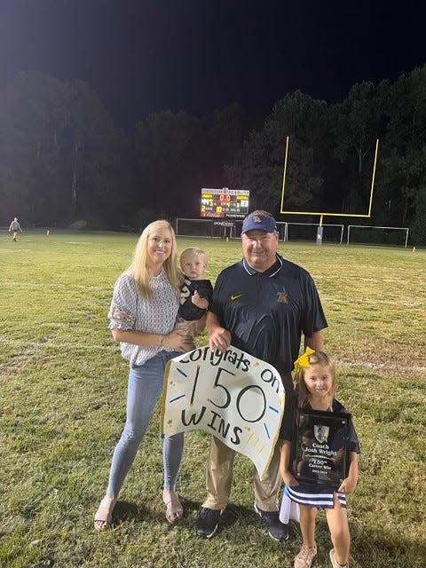 Coach Josh Wright and his family following his 150th career win on Friday night