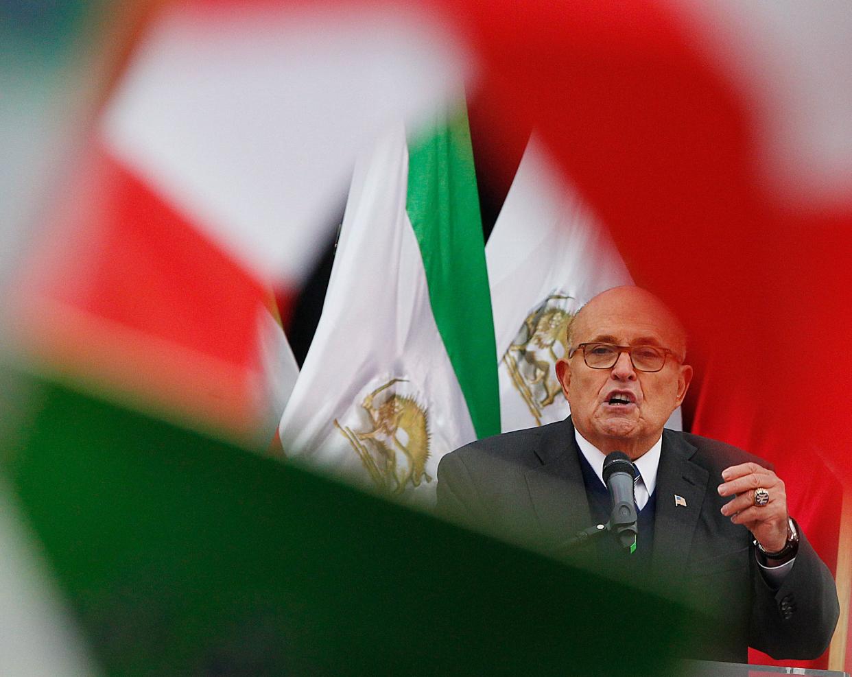 President Donald Trump's attorney Rudy Giuliani addresses a rally of a few hundred members of an Iranian opposition group ahead of a conference on the Middle East, in Warsaw, Poland, on Feb. 13, 2019.