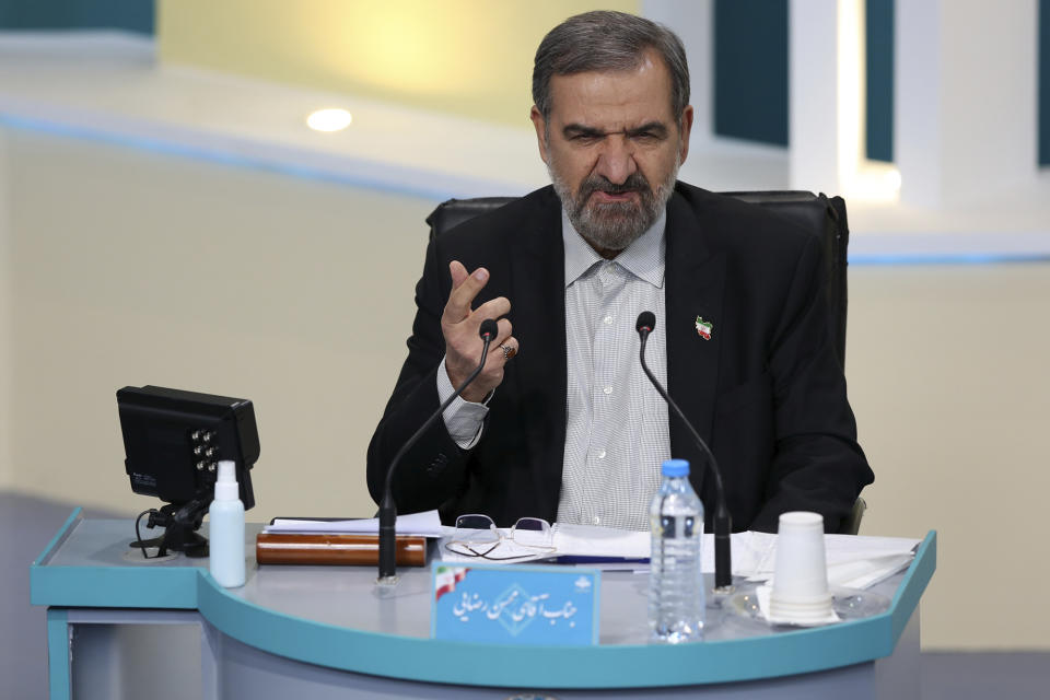 In this photo made available by the government-affiliated Young Journalists Club, presidential candidate Mohsen Rezaei speaks in a televised debate in a state-run television studio, in Tehran, Iran, on Saturday, June 5, 2021. Elections are scheduled for June 18. (Morteza Fakhri Nezhad/YJC via AP)