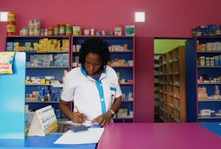 A vendor writes as she stands in a legal pharmacy in Abidjan, Ivory Coast October 16, 2018.  REUTERS/Luc Gnago