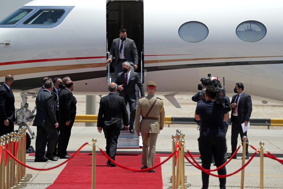 Jordan's King Abdullah II, center, arrives in Baghdad, Iraq, Sunday, June 27, 2021. (AP Photo/Khalid Mohammed)