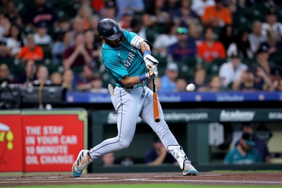 Seattle Mariners center fielder Julio Rodriguez hits a double to right field against the Houston Astros during an Aug. 20, 2023 game.