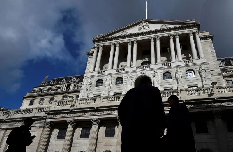 FILE PHOTO: City workers walking past the Bank of England in the City of London