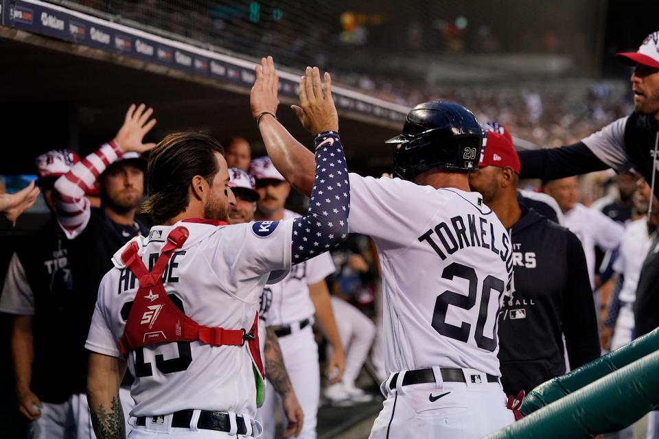 Detroit Tigers' Spencer Torkelson is greeted in the dugout after scoring from third on a RBI single by Riley Greene in the sixth inning of the second game of a doubleheader Monday in Detroit. The Tigers defeated the Guardians 5-3 after winning the first game 4-1. [Carlos Osorio/Associated Press]