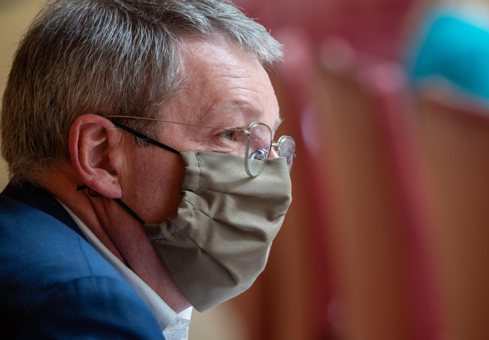 24 April 2020, Bavaria, Munich: Ernst Weidenbusch (CSU), member of the state parliament, is following the session of the Bavarian parliament with a face mask. Topics of the session include the second reading of the Corona supplementary budget and other legislative projects of the state government in the current pandemic. Photo: Peter Kneffel/dpa (Photo by Peter Kneffel/picture alliance via Getty Images)