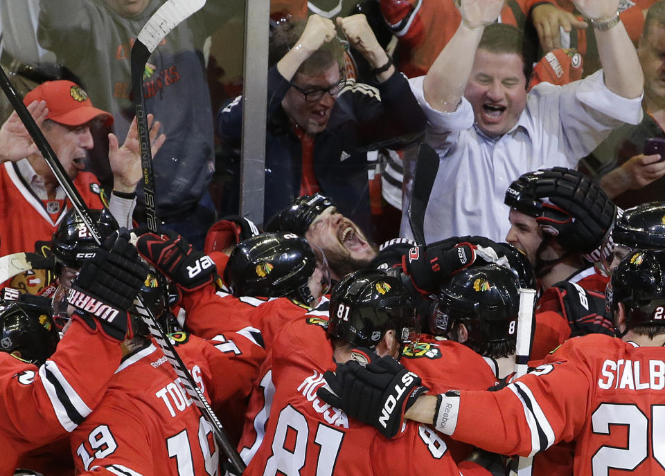 FILE - Chicago Blackhawks defenseman Brent Seabrook, at center looking up, celebrates with his teammates after scoring during overtime in Game 7 of the NHL hockey Stanley Cup Western Conference semifinals against the Detroit Red Wings in Chicago, in this Wednesday, May 29, 2013, file photo. The Blackhawks won 2-1. Longtime Chicago Blackhawks defenseman and three-time Stanley Cup winner Brent Seabrook announced Friday, March 5, 2021, he’s unable to continue playing hockey because of injury. (AP Photo/Nam Y. Huh, File)