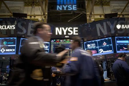 Traders work on the floor of the New York Stock Exchange December 16, 2014. REUTERS/Brendan McDermid