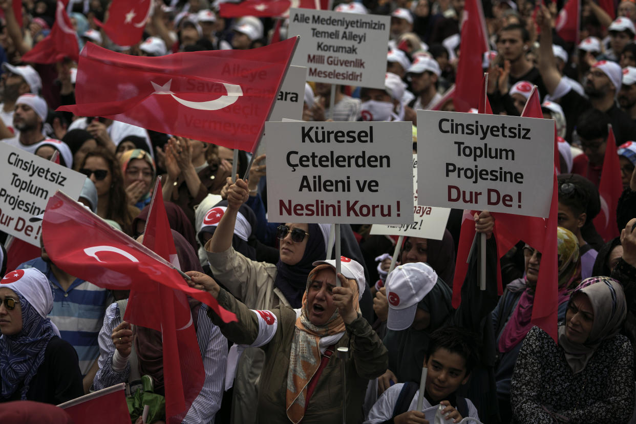 Turkish demonstrators chant slogans while holding Turkish flags and banners that read, " Say stop to the non gendered society project", " The family is our civilization's foundation, protecting family is a national security issue" and " Protect your family and generation from global fan", during a anti LGBTI+ protest, in Fatih district of Istanbul, Sunday, Sept. 18, 2022. (AP Photo/Khalil Hamra)