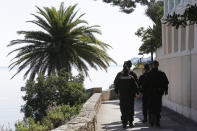 Police officers patrol along the Villa Kerylos in Beaulieu-sur-Mer, southern France, Sunday, March, 24, 2019, where French President Emmanuel Macron and Chinese President Chinese President Xi Jinping will meet. A police boat and police divers worked to secure the area before his arrival, and security cordons blocked several roads in Nice, where Xi will stay overnight. (AP Photo/Claude Paris)