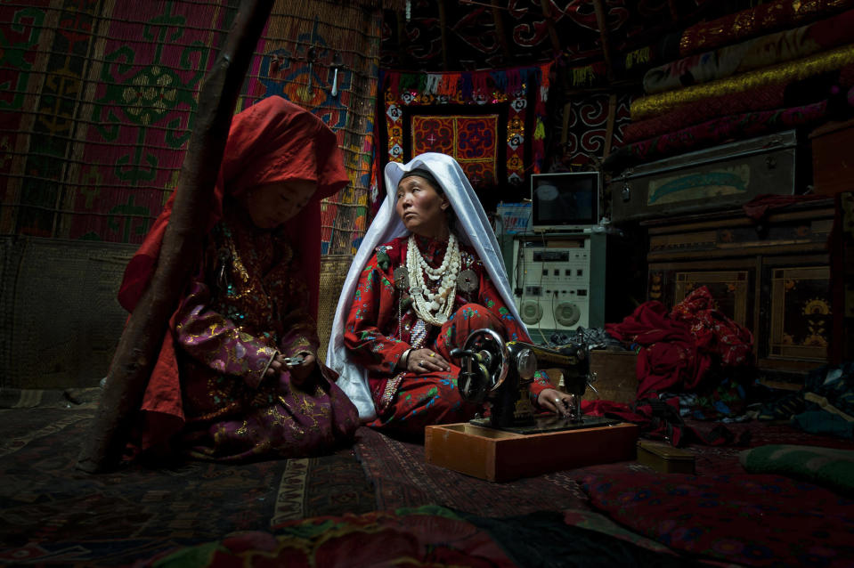 First Place: This image was shot in the Kyrgyz lands of the Wakhan Corridor. The intimacy of this everyday life moment, shot inside of a family yurt, is in total contrast with the harsh environment these nomadic tribes live in. On the right we notice a television and a sound console. These tribes live weeks away from any village by foot. In spite of being located at an altitude of 4,300 meters in one of the most remote areas of Afghanistan they are equipped with solar panels, satellite dishes and cellphones. Ancestral ways of living, with touches of modernity. (Photo and caption by Cedric Houin/National Geographic Traveler Photo Contest) <br> <br> <a href="http://travel.nationalgeographic.com/travel/traveler-magazine/photo-contest/2012/entries/gallery/winners/" rel="nofollow noopener" target="_blank" data-ylk="slk:Click here to see the National Geographic Traveler's Winners Gallery;elm:context_link;itc:0;sec:content-canvas" class="link ">Click here to see the National Geographic Traveler's Winners Gallery</a>