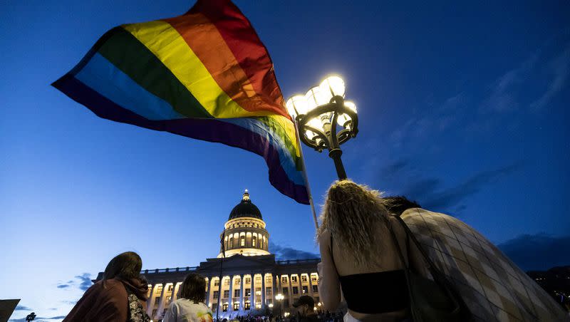 Participants listen to speakers during the Pride Glow March at the Capitol June 3, 2022. Utah Gov. Spencer Cox on Wednesday signing a bill banning so-called conversion therapy on minors.