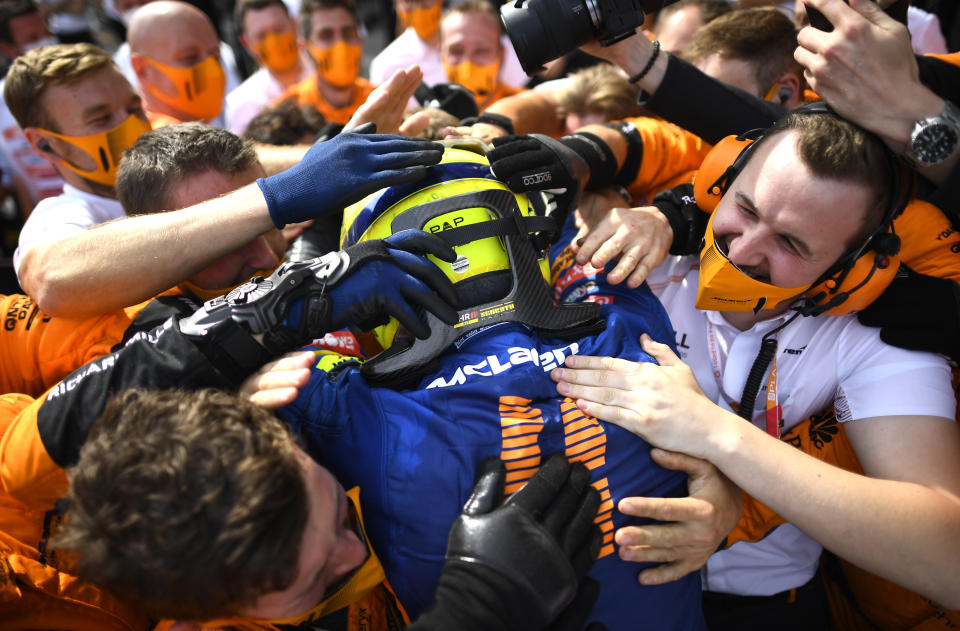 Mclaren driver Lando Norris of Britain is congratulated after taking third place in the Austrian Formula One Grand Prix at the Red Bull Ring racetrack in Spielberg, Austria, Sunday, July 4, 2021. (Christian Bruna/Pool Photo via AP)