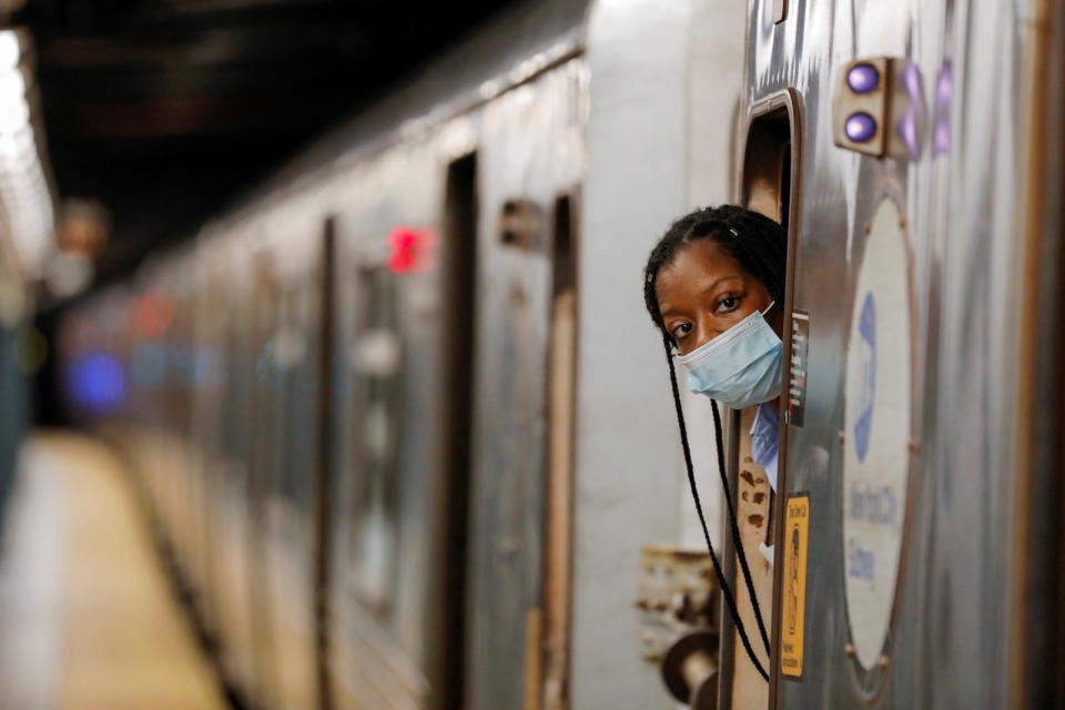 An MTA worker is seen wearing a mask on the subway after The Port Authority of New York and New Jersey and the Metropolitan Transportation Authority (MTA) announced a mandatory coronavirus vaccination or weekly test mandate for employees in New York City, New York, U.S., August 2, 2021. REUTERS/Andrew Kelly - RC22XO9OQ7R0