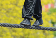 Wallenda’s feet take careful steps on the wire.