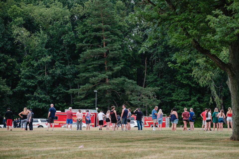 People gather at the scene of a plane crash where a single-piston Cessna Skyhawk went down Monday at Ellet Community Center in Akron.