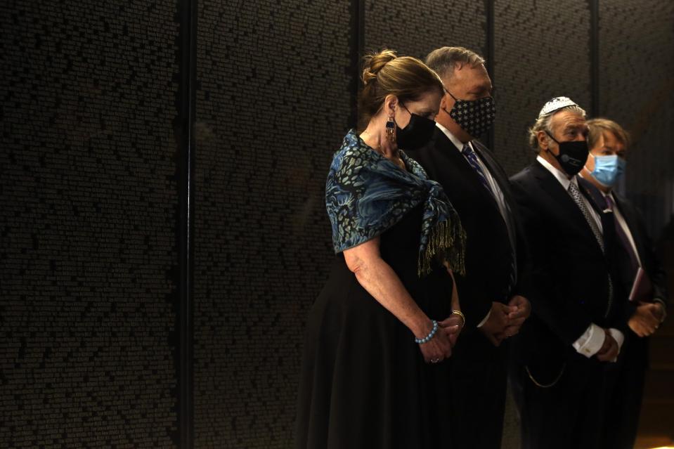 U.S. Secretary of State Mike Pompeo, second left, and his wife Susan, left, observe one minute of silence during their visit at the Jewish Museum in the northern city of Thessaloniki, Greece, Monday, Sept. 28, 2020. Pompeo said Monday the United States will use its diplomatic and military influence in the region to try to ease a volatile dispute between NATO allies Greece and Turkey over energy rights in the eastern Mediterranean. (AP Photo/Giannis Papanikos, Pool)