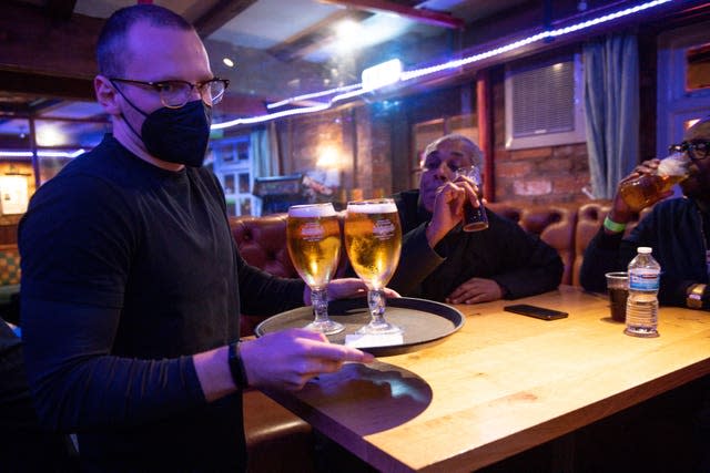 A man carries a tray of drinks