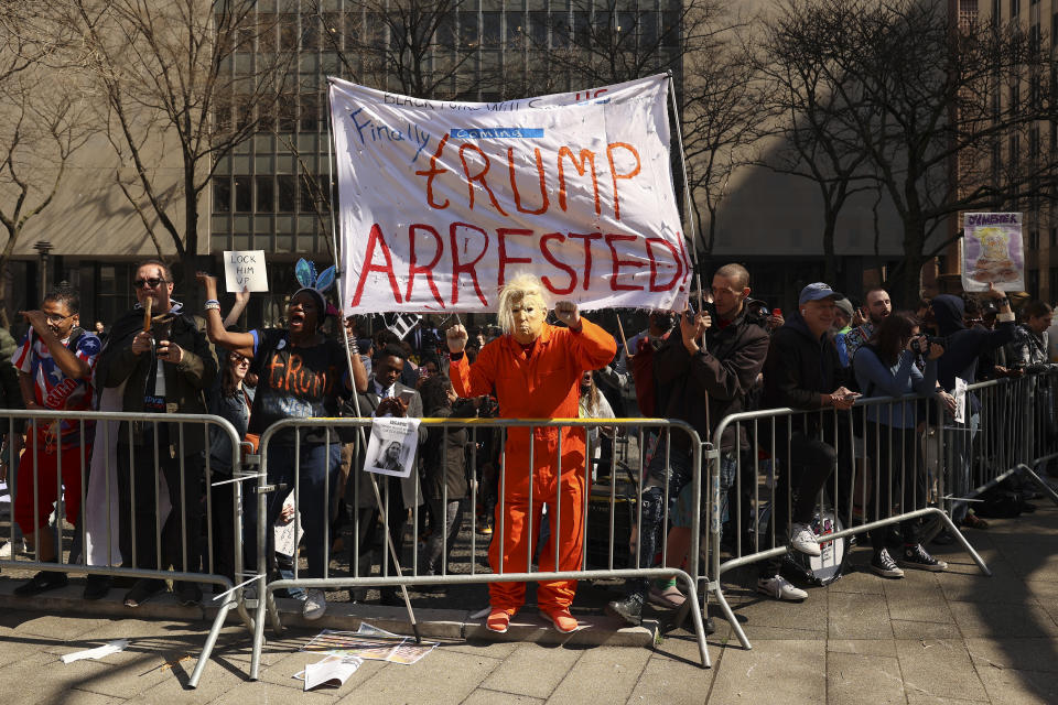 Demonstrators gather outside New York criminal court, Tuesday, April 4, 2023, in New York. Former President Donald Trump is set to appear in a New York City courtroom on charges related to falsifying business records in a hush money investigation, the first president ever to be charged with a crime.(AP Photo/Yuki Iwamura)