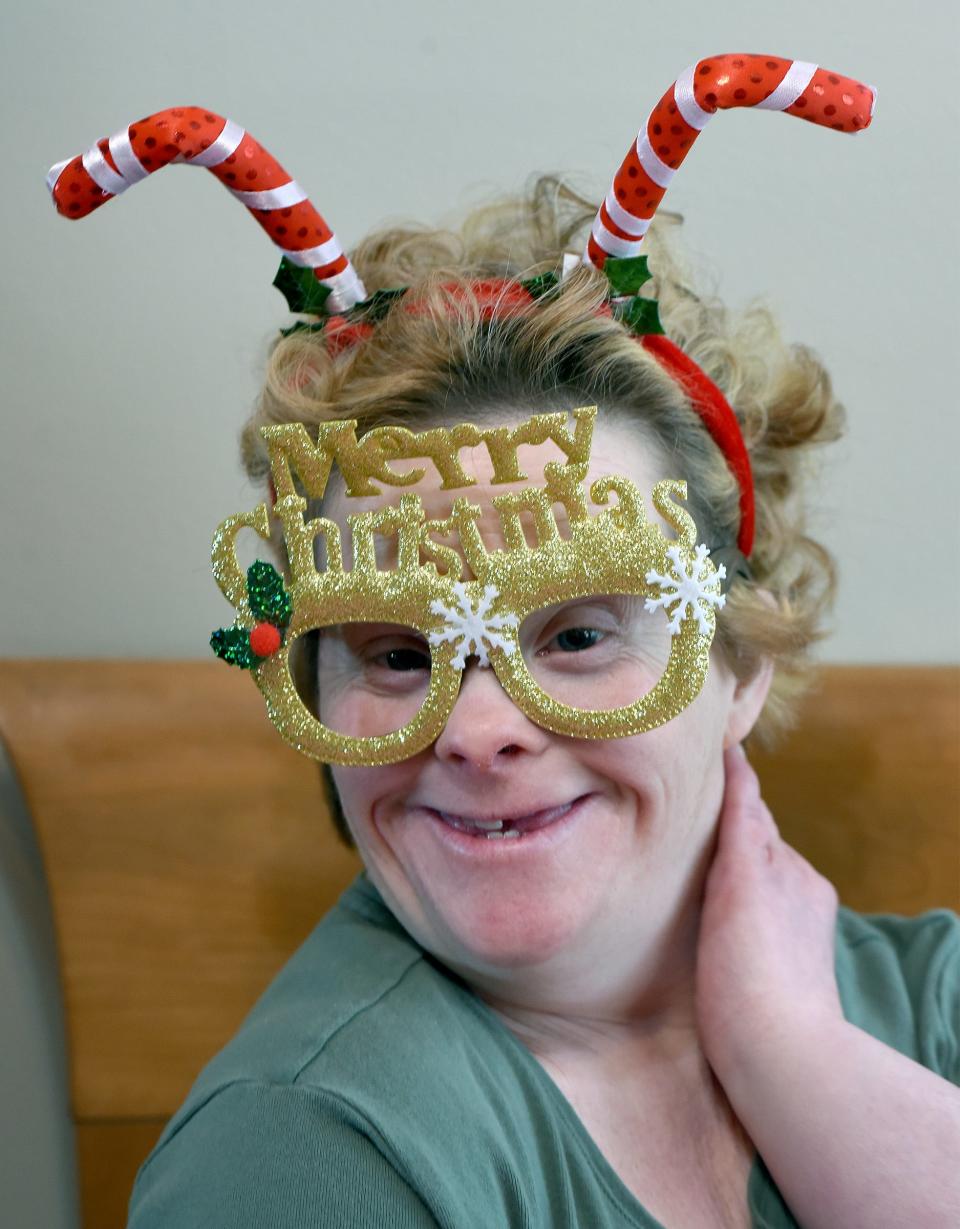 Leslie Larkins likes to pose above with silly Christmas glasses and head band.