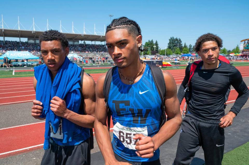 Federal Way teammates Jaylon Jenkins (from left), Julian Gene Fortin and Roman Hutchinson leave the field after sweeping the top three spots in the 4A boys triple jump competition during the second day of the WIAA state track and field championships at Mount Tahoma High School in Tacoma, Washington, on Friday, May 26, 2023. Hutchinson won the event, with Jenkins second and Fortin third.