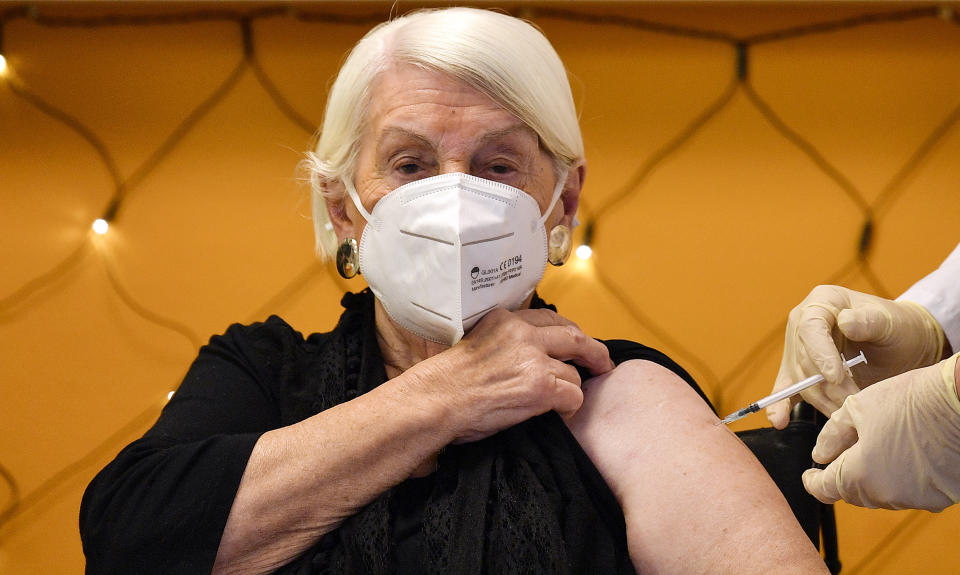 Ninety-two year-old nursing home resident Gertrud Vogel gets an injection of the COVID-19 vaccine in Cologne, Germany, Sunday, Dec. 27, 2020. The first shipments of coronavirus vaccines developed by BioNTech and Pfizer have arrived across the European Union, and authorities started to vaccinate the most vulnerable people in a coordinated effort on Sunday. (AP Photo/Martin Meissner)