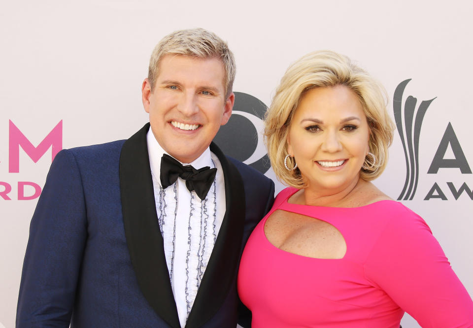 LAS VEGAS, NV - APRIL 02:  Todd Chrisley and Julie Chrisley arrive at the 52nd Academy of Country Music Awards held at T-Mobile Arena on April 2, 2017 in Las Vegas, Nevada.  (Photo by Michael Tran/FilmMagic)