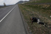 An Afghan migrant rests during a break from his walk along a main road after crossing the Turkey-Iran border near Erzurum, eastern Turkey, April 12, 2018. Picture taken April 12, 2018. REUTERS/Umit Bektas