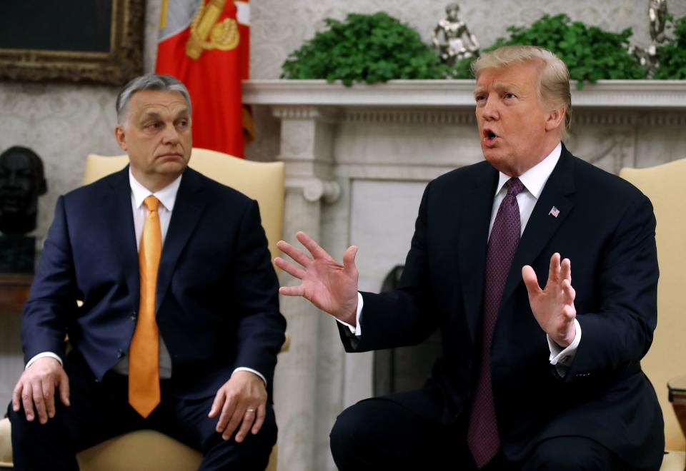 Viktor Orban, left, watches on as Donald Trump, right, speaks.