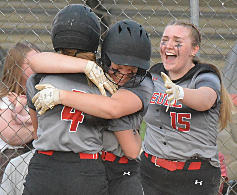 Deuel players Emma Hamann (4), Harley Hennings (14) and Roxanne Raml (15) after Hennings scored the winning run in their 6-5 eight-inning win over Scotland-Menno in a Class B SoDak 16 state-qualifying softball game on Tuesday, May 23, 2023 in Clear Lake.