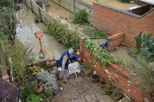 John Badham checks the pumps in his back garden are working (Ben Birchall/PA).