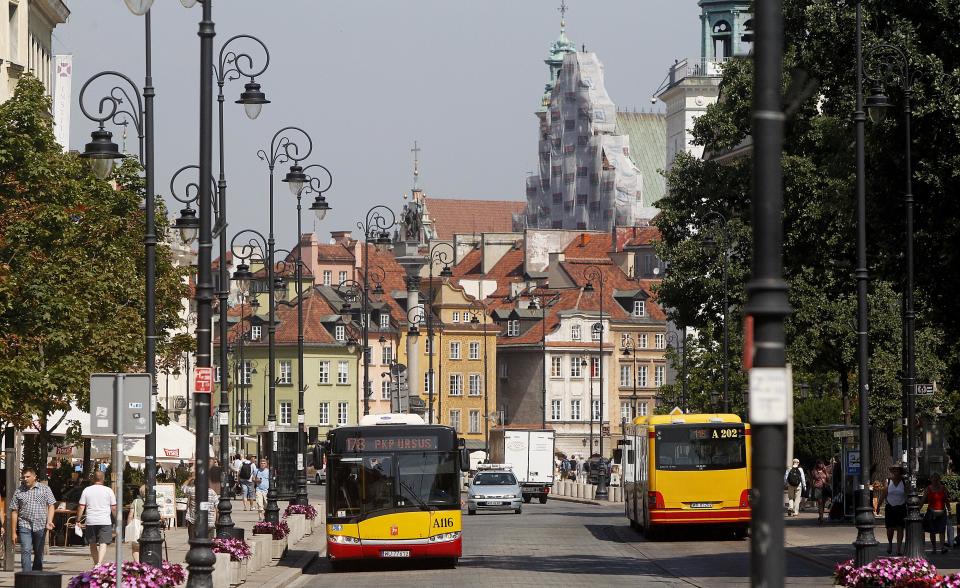 This Aug. 6, 2013 photo shows people walking on the Krakowskie Przedmiescie street, a part of the 11 kilometres (7 miles) long Royal Route in Warsaw, Poland. The Royal Route runs from Warsaw’s Old Town, south, to the Baroque royal mansion of Wilanow. You can take a 2-kilometer stroll from Charles de Gaulle roundabout, with its landmark plastic palm tree, to the Old Town that dates back to the 13th century. (AP Photo/Czarek Sokolowski)