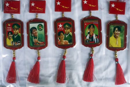 Car rearview mirror charms with pictures of Aung San Suu Kyi and her father, the country's independence hero General Aung San, are photographed in a printing shop in Yangon April 5, 2015. REUTERS/Minzayar