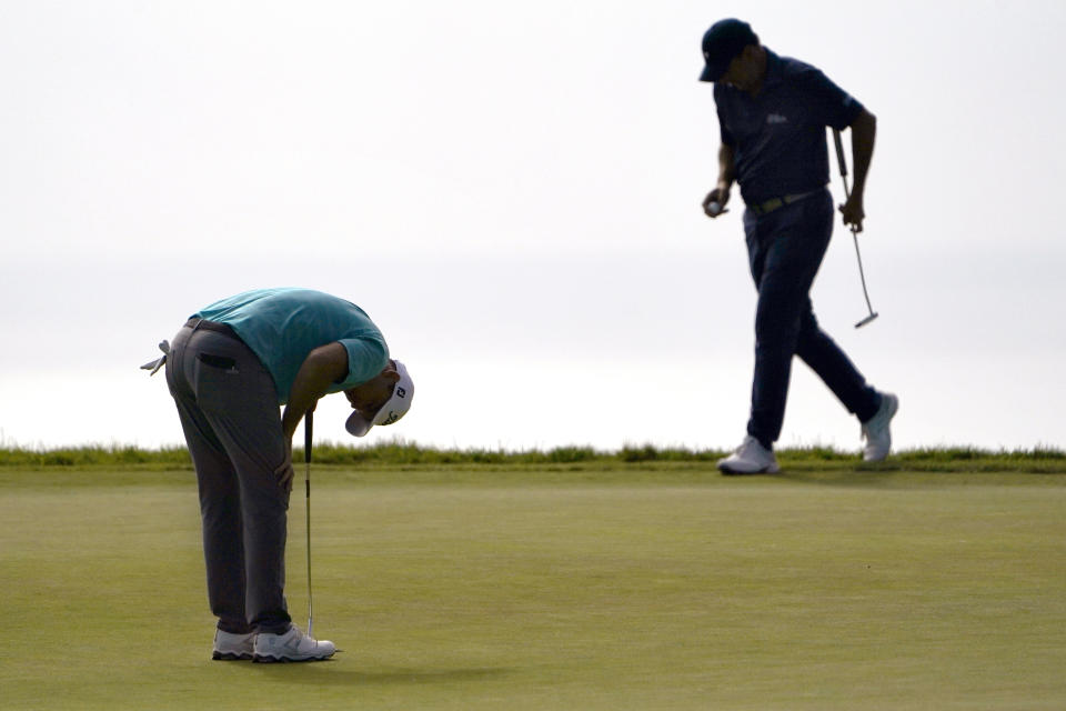 Russell Henley, left, reacts after missing his putt on the 14th green as Richard Bland, of England, prepares to hit during the third round of the U.S. Open Golf Championship, Saturday, June 19, 2021, at Torrey Pines Golf Course in San Diego. (AP Photo/Jae C. Hong)