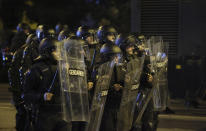 Riot police face fans during the Euro 2024 Bulgaria v Hungary soccer match, played at closed doors, in Sofia, Thursday, Nov. 16, 2023. Thousands of Bulgarian football supporters have taken to the streets of the capital, Sofia, in protest over the management of the national football union, a demonstration that eventually turned violent. The European soccer qualifier between Bulgaria and Hungary fell victim to a bitter dispute between the management of the Bulgarian Football Union and soccer fans from across the Balkan country. (AP Photo/Valentina Petrova)