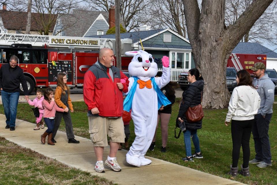 Port Clinton Mayor Mike Snider escorts the Easter Bunny from the fire truck to the egg hunt at Lakeview Park at a past event.