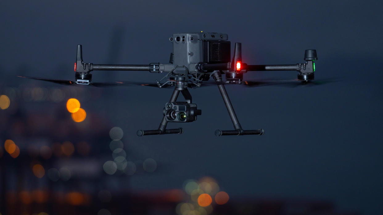  DJI Matrice 350RTK (or M350 RTK) flying at night over a container port 