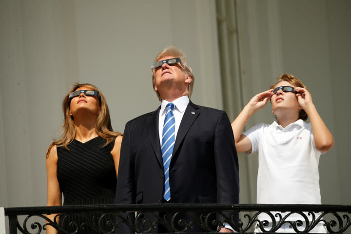 President Trump with first lady Melania Trump and their son, Barron, watch from the Truman Balcony at the White House. (Photo: Kevin Lamarque/Reuters)