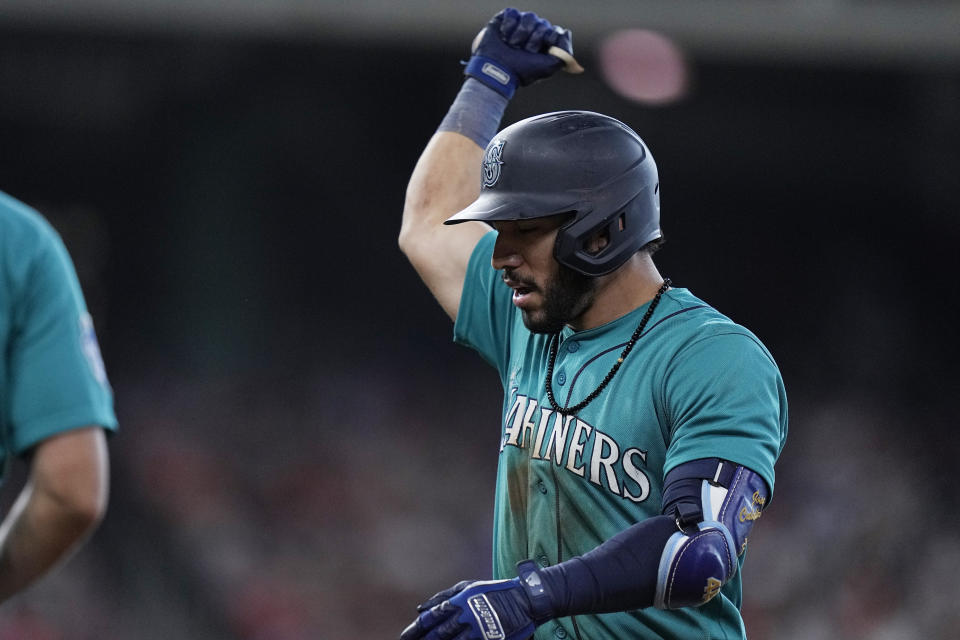 Seattle Mariners' Jose Caballero celebrates after hitting an RBI single against the Houston Astros during the fourth inning of a baseball game Saturday, July 8, 2023, in Houston. (AP Photo/Kevin M. Cox)