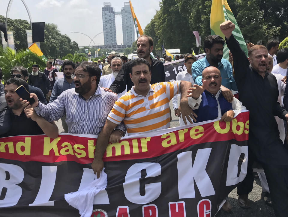 Pakistani Kashmiris observe Black Day on the occasion of India's Independence Day near Indian High Commission in Islamabad, Pakistan, Thursday, Aug. 15, 2019. Pakistan's prime minister has questioned the silence of world community over recent change in the status of Indian-administered sector of Kashmir by New Delhi and lingering imposition of security clampdown which deprived Kashmiri people of their basic rights. (AP Photo/B.K. Bangash)