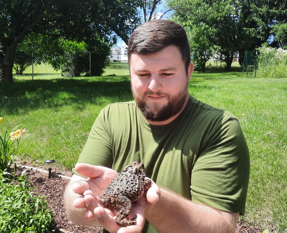 Aaron Capouellez holds Ace, an American toad, that he has cared for over the last seven years.