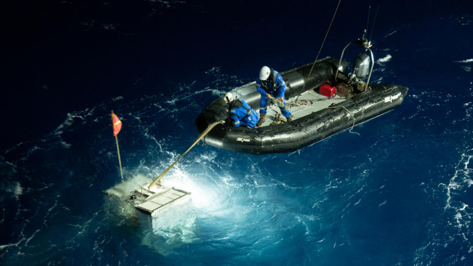 A navigational lander is retrieved in a risky operation after his journey to the Challenger Deep. - Credit: Michael Dubno