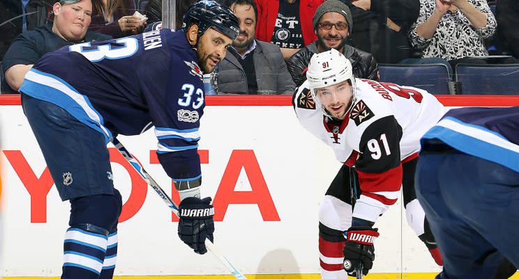 Dustin Byfuglien #33 of the Winnipeg Jets and Alexander Burmistrov #91 of the Arizona Coyotes line up against each other. (Jonathan Kozub/Getty Images)