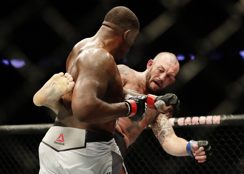 England’s Mark Godbeer, right, kicks Walt Harris during a heavyweight mixed martial arts bout at UFC 217 Saturday, Nov. 4, 2017, in New York. Godbeer won after Harris was disqualified. (AP Photo/Frank Franklin II)