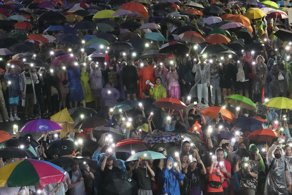 Supporters of the Move Forward Party display mobile phones with flash lights on during a protest in Bangkok, Thailand, Sunday, July 23, 2023. The demonstrators are protesting that Thailand's Constitution is undemocratic, because it allowed Parliament to block the winner of May's general election, the Move Forward Party, from naming its leader as the new prime minister, even though he had assembled an eight-part coalition that had won a clear majority of seats in the House of Representatives. (AP Photo/Sakchai Lalit)