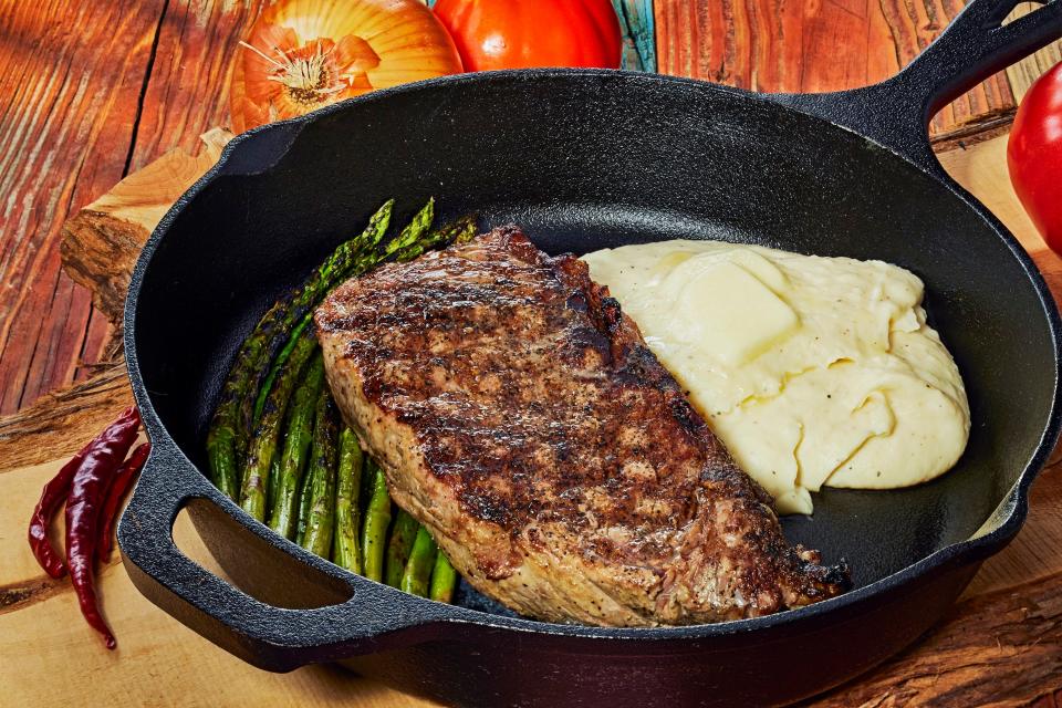 A 16-ounce char-grilled New York strip steak and homestyle mashed potatoes from Uncle Chicken's Cast Iron Kitchen in New Smyrna Beach.