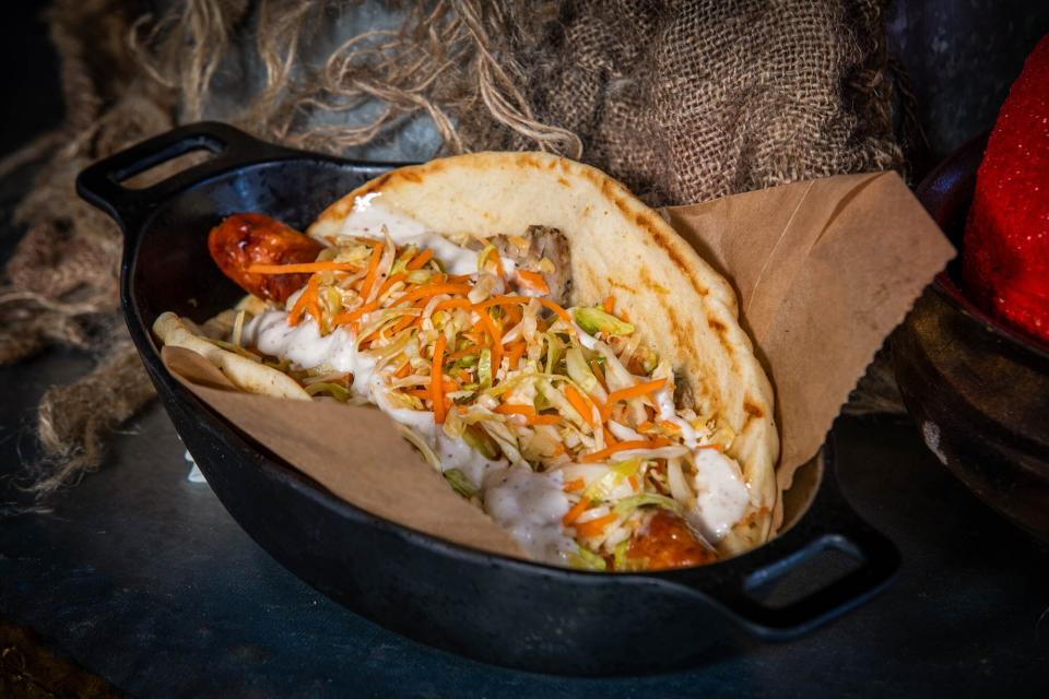A Ronto Wrap with grilled pork sausage on pita bread on display at the Ronto Roaster as media members get a preview during the Star Wars: Galaxy's Edge Media Preview event at the Disneyland Resort