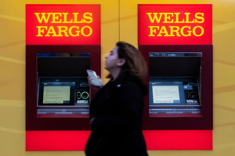 FILE PHOTO: A woman walks past Wells Fargo bank in New York City