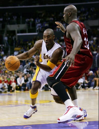 Los Angeles Lakers star Kobe Bryant, left, drives on Miami's Shaquille O'Neal in a Christmas 2014 NBA matchup